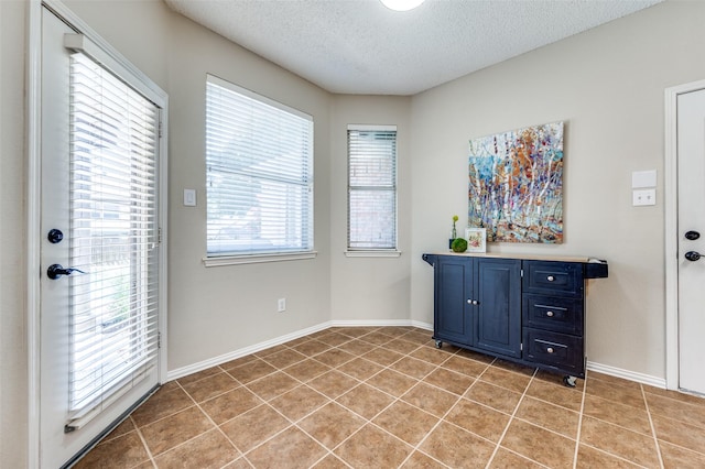 2701 Timberhill Dr, Flower Mound, TX 75028 - unfurnished dining area featuring a textured ceiling and light tile patterned floors