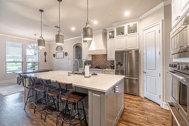 3240 Glenmore Ave, Northlake, TX 76247 - kitchen featuring appliances with stainless steel finishes, custom exhaust hood, ornamental molding, dark wood finished floors, and backsplash