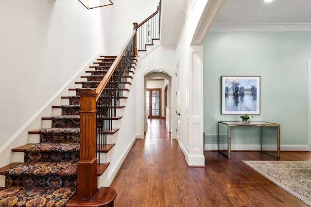 2812 Purdue St, University Park, TX 75225 - staircase with arched walkways, wood finished floors, a high ceiling, and crown molding