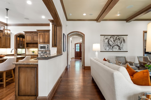 2812 Purdue St, University Park, TX 75225 - living area with arched walkways, dark wood-style floors, beam ceiling, recessed lighting, and crown molding