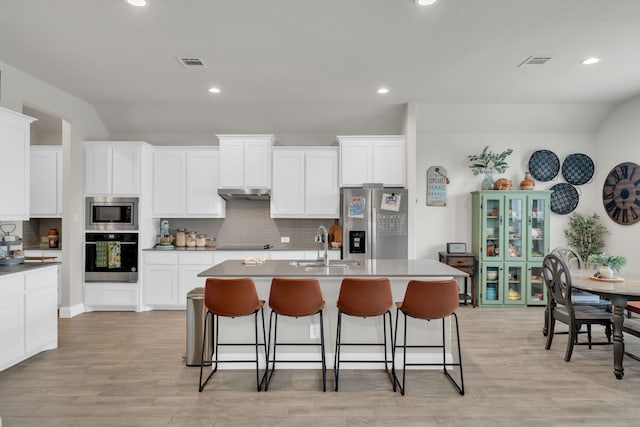 621 Mesquite Grove Rd, Midlothian, TX 76065 - kitchen with stainless steel appliances, tasteful backsplash, recessed lighting, under cabinet range hood, and a kitchen island with sink