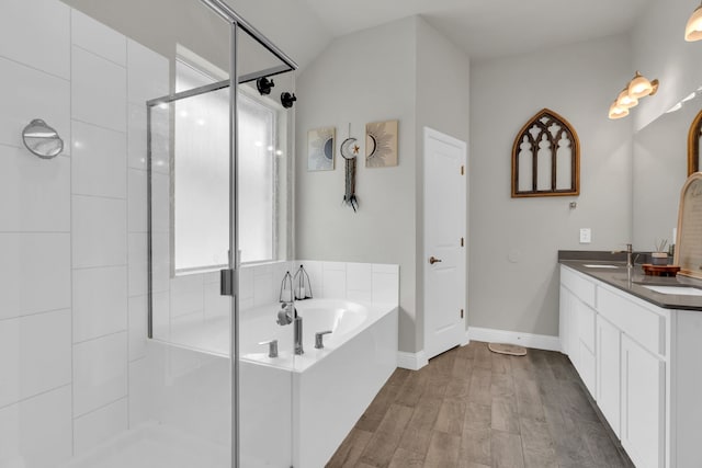 621 Mesquite Grove Rd, Midlothian, TX 76065 - bathroom with a garden tub, a shower stall, double vanity, and wood finished floors