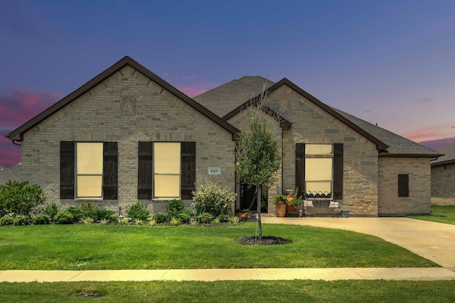 621 Mesquite Grove Rd, Midlothian, TX 76065 - french country style house featuring a lawn, roof with shingles, stone siding, and brick siding