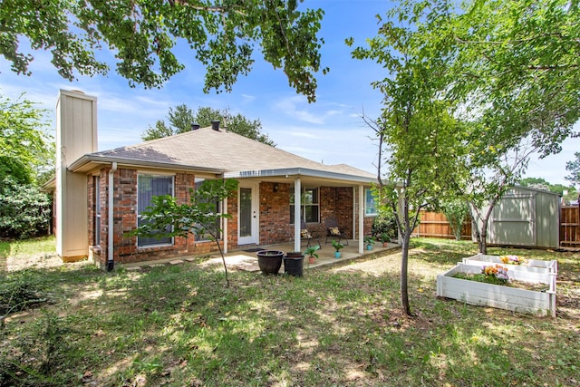 2073 Rushmore Ct, Lewisville, TX 75067 - back of house featuring a chimney, a garden, a patio, a shed, and a shingled roof