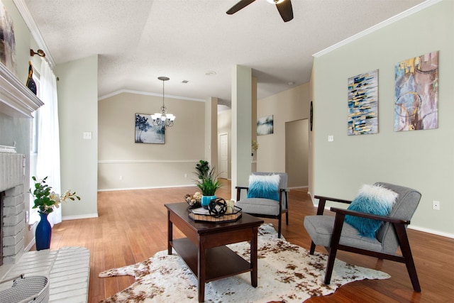 2073 Rushmore Ct, Lewisville, TX 75067 - living room with ceiling fan, a chandelier, a brick fireplace, wood finished floors, and crown molding