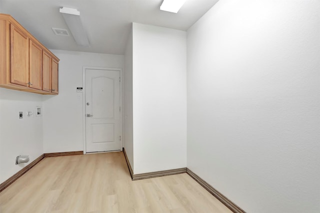1629 Lakeside Dr, Allen, TX 75002 - laundry area featuring electric dryer hookup, light wood-style flooring, cabinet space, and washer hookup