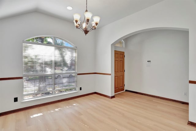 1629 Lakeside Dr, Allen, TX 75002 - empty room with arched walkways, light wood-style flooring, a chandelier, and lofted ceiling