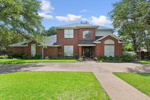 10003 Willow Bend Dr, Woodway, TX 76712 - view of front of property featuring a front lawn, a shingled roof, and brick siding