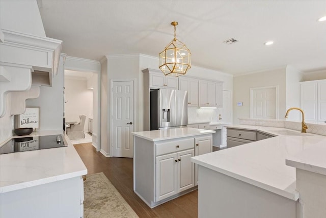 10003 Willow Bend Dr, Woodway, TX 76712 - kitchen featuring stainless steel fridge with ice dispenser, a large island, dark wood-type flooring, black electric cooktop, and ornamental molding