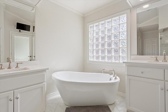 10003 Willow Bend Dr, Woodway, TX 76712 - bathroom featuring two vanities, a freestanding bath, marble finish flooring, and crown molding