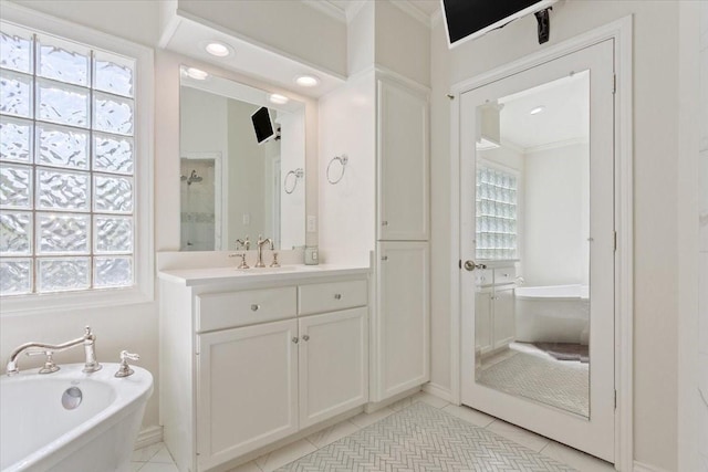 10003 Willow Bend Dr, Woodway, TX 76712 - bathroom featuring a freestanding bath, ornamental molding, vanity, plenty of natural light, and tile patterned flooring