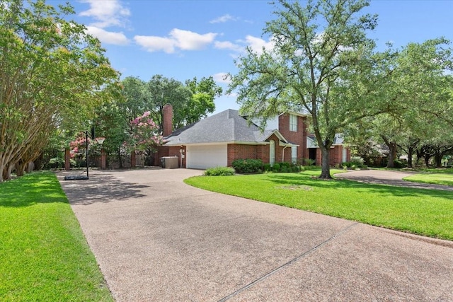 10003 Willow Bend Dr, Woodway, TX 76712 - view of front of home featuring concrete driveway, an attached garage, a front lawn, and brick siding
