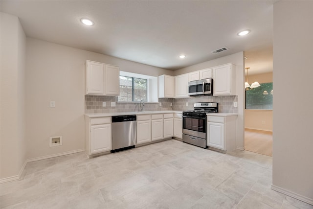 5048 Hollow Ridge Rd, Dallas, TX 75227 - kitchen with stainless steel appliances, light countertops, backsplash, white cabinetry, and recessed lighting