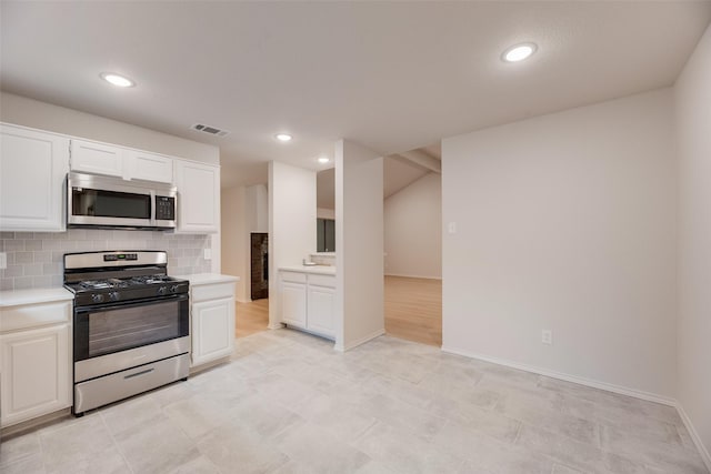 5048 Hollow Ridge Rd, Dallas, TX 75227 - kitchen with appliances with stainless steel finishes, light countertops, white cabinets, decorative backsplash, and recessed lighting