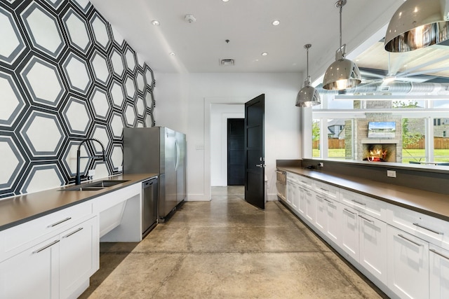313 Savannah Ln, Oak Point, TX 75068 - kitchen featuring stainless steel appliances, dark countertops, concrete floors, plenty of natural light, and recessed lighting