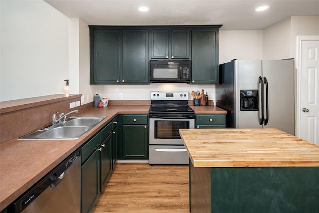 9028 Wild Rose Ln, Cross Roads, TX 76227 - kitchen with stainless steel appliances, wooden counters, light wood-style floors, recessed lighting, and a kitchen island