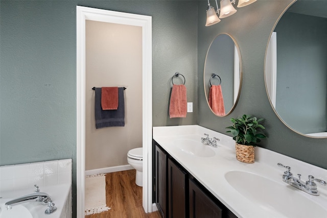 9028 Wild Rose Ln, Cross Roads, TX 76227 - full bathroom with double vanity, wood finished floors, and a garden tub