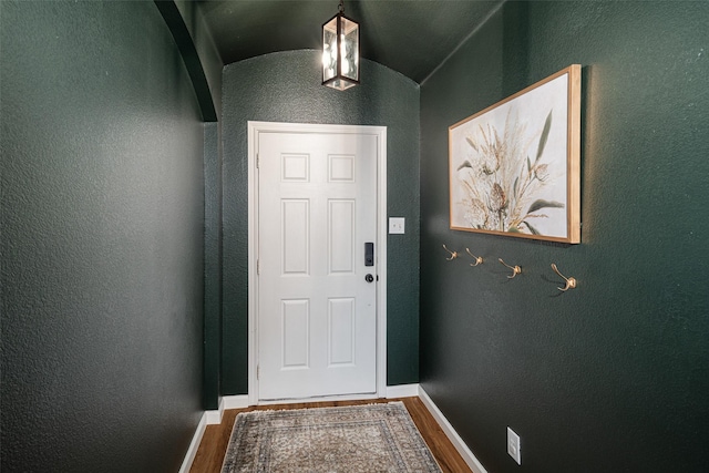 9028 Wild Rose Ln, Cross Roads, TX 76227 - doorway with wood finished floors, a textured wall, and vaulted ceiling