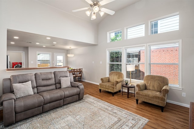 9028 Wild Rose Ln, Cross Roads, TX 76227 - living area featuring wood finished floors, high vaulted ceiling, ceiling fan, washer / clothes dryer, and recessed lighting