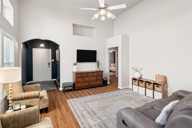 9028 Wild Rose Ln, Cross Roads, TX 76227 - living room featuring high vaulted ceiling, wood finished floors, ceiling fan, and arched walkways