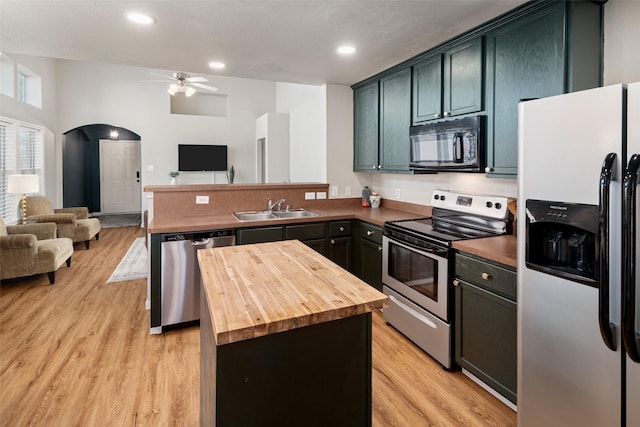 9028 Wild Rose Ln, Cross Roads, TX 76227 - kitchen with stainless steel appliances, butcher block counters, open floor plan, ceiling fan, and a peninsula