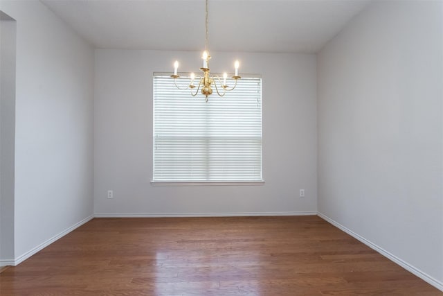 738 Opal Ln, Mesquite, TX 75149 - unfurnished room with a chandelier and wood finished floors