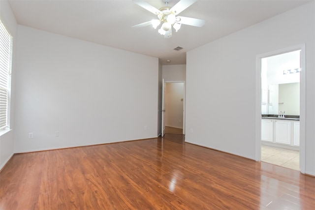 738 Opal Ln, Mesquite, TX 75149 - unfurnished room featuring light wood-style flooring and a ceiling fan