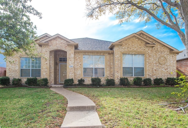 738 Opal Ln, Mesquite, TX 75149 - view of front facade with brick siding, a front lawn, and a shingled roof