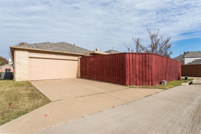 738 Opal Ln, Mesquite, TX 75149 - view of home's exterior featuring an attached garage, driveway, and brick siding