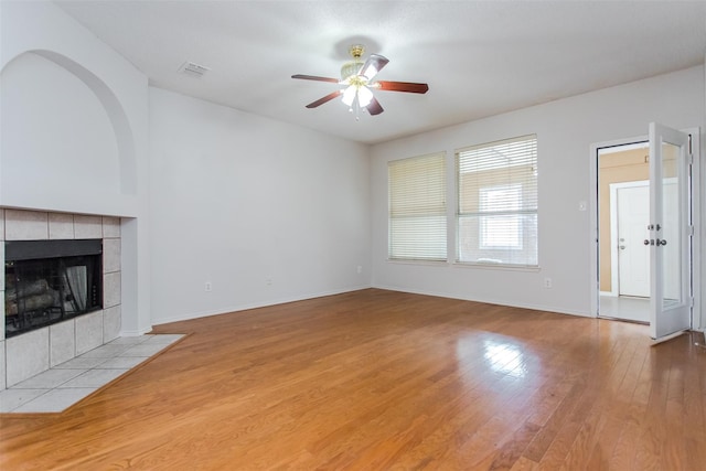 738 Opal Ln, Mesquite, TX 75149 - unfurnished living room featuring ceiling fan, wood finished floors, and a fireplace