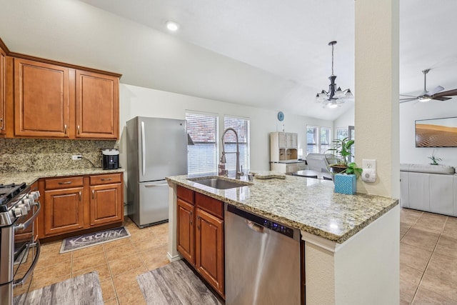 504 Lake Point Dr, Little Elm, TX 75068 - kitchen featuring stainless steel appliances, light tile patterned floors, vaulted ceiling, open floor plan, and ceiling fan