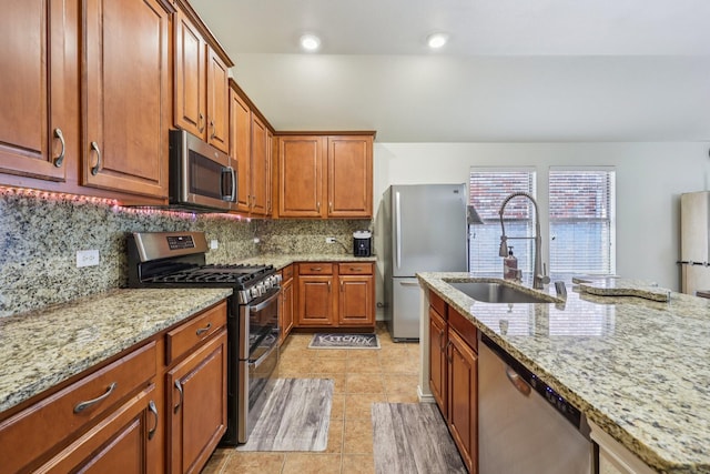 504 Lake Point Dr, Little Elm, TX 75068 - kitchen with appliances with stainless steel finishes, light stone counters, tasteful backsplash, and light tile patterned floors
