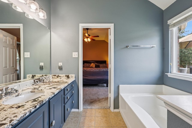 504 Lake Point Dr, Little Elm, TX 75068 - ensuite bathroom featuring vanity, a garden tub, ceiling fan, and tile patterned flooring