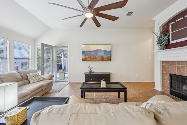 504 Lake Point Dr, Little Elm, TX 75068 - living area with tile patterned floors, a ceiling fan, a fireplace, and vaulted ceiling