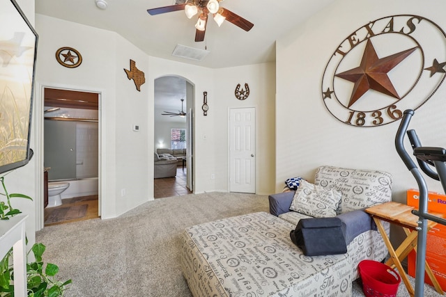 504 Lake Point Dr, Little Elm, TX 75068 - tiled bedroom featuring carpet floors, arched walkways, ensuite bath, and a ceiling fan