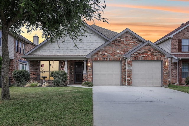 504 Lake Point Dr, Little Elm, TX 75068 - view of front of property featuring a front yard, concrete driveway, a garage, and brick siding