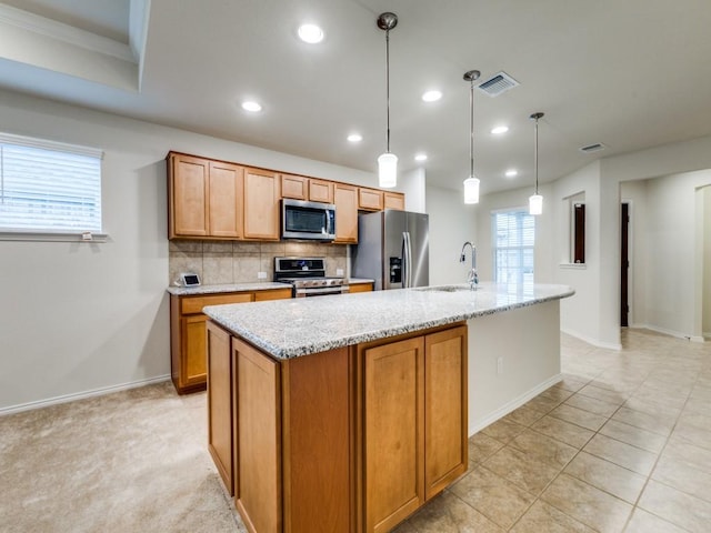 1244 Eagle Ln, Little Elm, TX 76227 - kitchen with appliances with stainless steel finishes, recessed lighting, decorative backsplash, a kitchen island with sink, and brown cabinetry