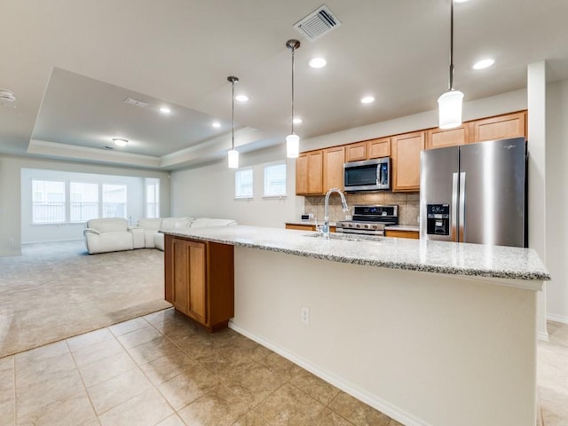 1244 Eagle Ln, Little Elm, TX 76227 - kitchen with appliances with stainless steel finishes, light colored carpet, a raised ceiling, recessed lighting, and open floor plan