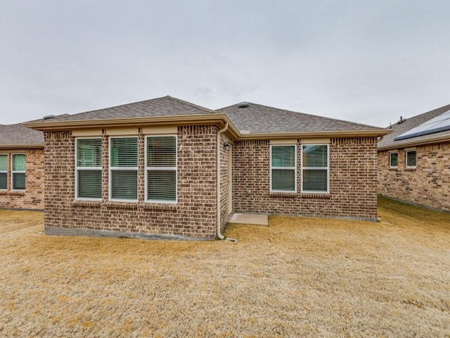 1244 Eagle Ln, Little Elm, TX 76227 - rear view of house with brick siding, a shingled roof, and a yard