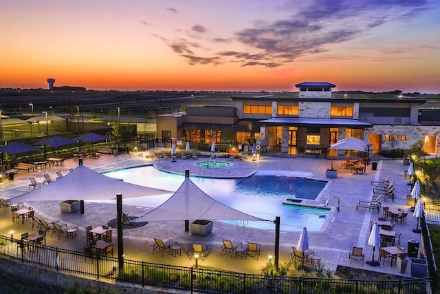 1244 Eagle Ln, Little Elm, TX 76227 - pool at dusk featuring a community pool, a hot tub, and a patio