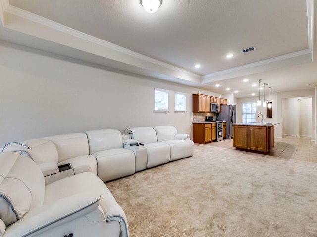 1244 Eagle Ln, Little Elm, TX 76227 - living area featuring a raised ceiling, ornamental molding, recessed lighting, and light carpet