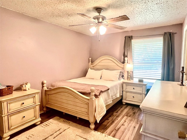 309 Bellaire Dr, Denton, TX 76209 - bedroom featuring wood finished floors, ceiling fan, and a textured ceiling