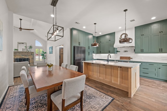 1402 Summer Dell Ct, Keller, TX 76262 - dining space with a fireplace, light wood-type flooring, a ceiling fan, recessed lighting, and lofted ceiling
