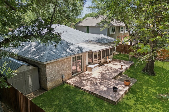 2521 Misty Glen Dr, Flower Mound, TX 75028 - rear view of house with roof with shingles, a storage unit, a sunroom, a patio, and brick siding