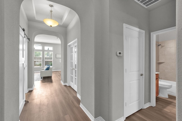 813 Louisville Rd, Savannah, TX 76227 - hallway with arched walkways, wood finished floors, and a barn door