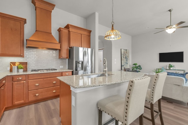 813 Louisville Rd, Savannah, TX 76227 - kitchen with appliances with stainless steel finishes, custom range hood, light wood-style flooring, open floor plan, and lofted ceiling