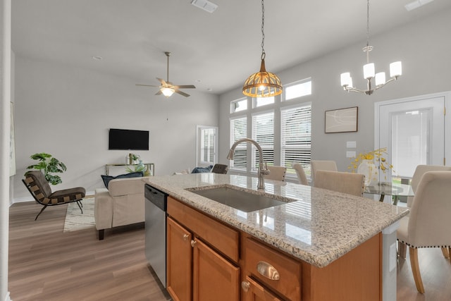 813 Louisville Rd, Savannah, TX 76227 - kitchen featuring light wood-type flooring, open floor plan, a chandelier, and an island with sink