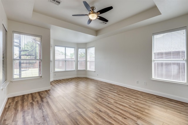4513 Southpointe Dr, Richardson, TX 75082 - empty room featuring a tray ceiling, a ceiling fan, and light wood finished floors