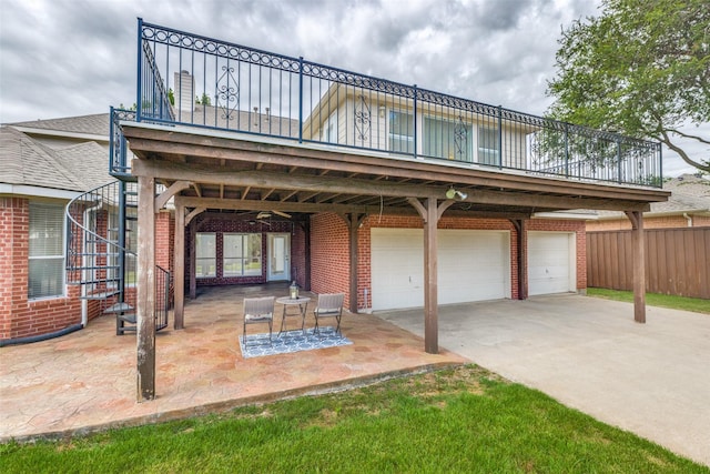 4513 Southpointe Dr, Richardson, TX 75082 - back of house featuring a garage, brick siding, concrete driveway, and a patio
