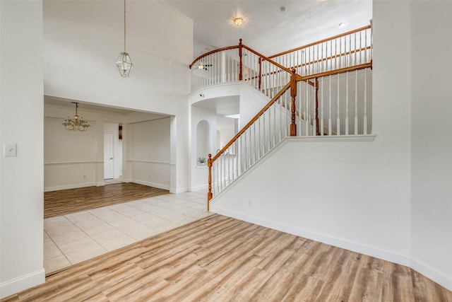 4513 Southpointe Dr, Richardson, TX 75082 - entrance foyer with stairs, arched walkways, wood finished floors, a chandelier, and a high ceiling